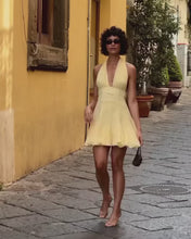 Load and play video in Gallery viewer, Chic Light Yellow Halter Homecoming Dress with Deep V-Neck and Flowy Skirt